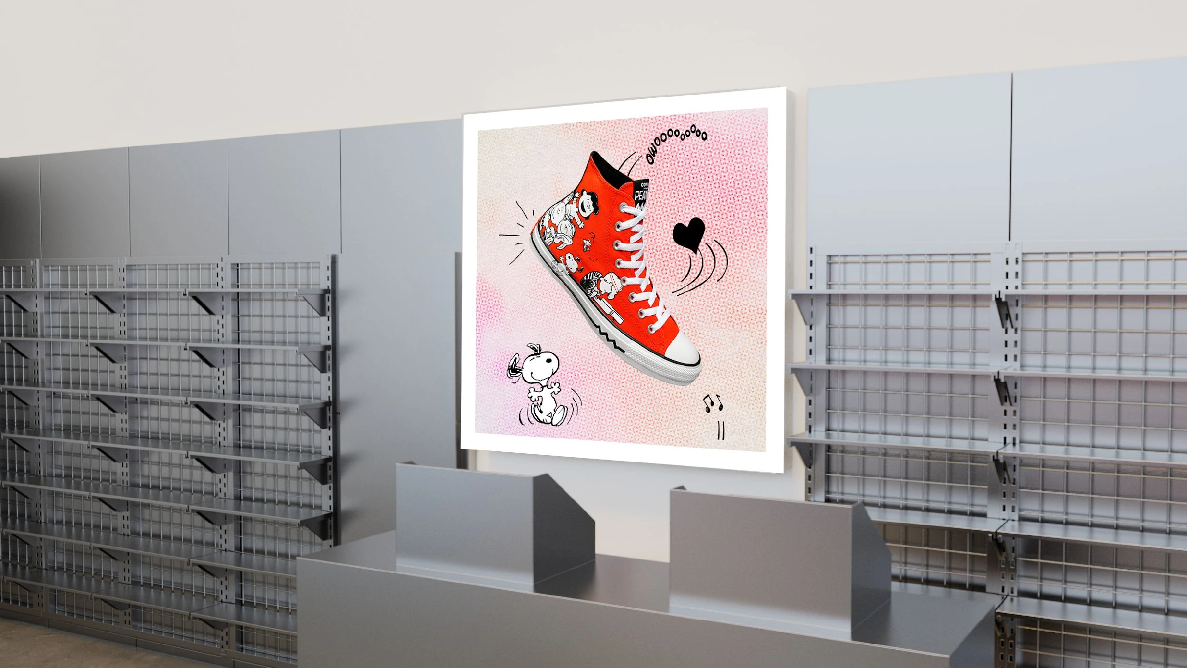 A framed hero poster of the red Peanuts Chuck Taylor mounted on a retail shelving wall