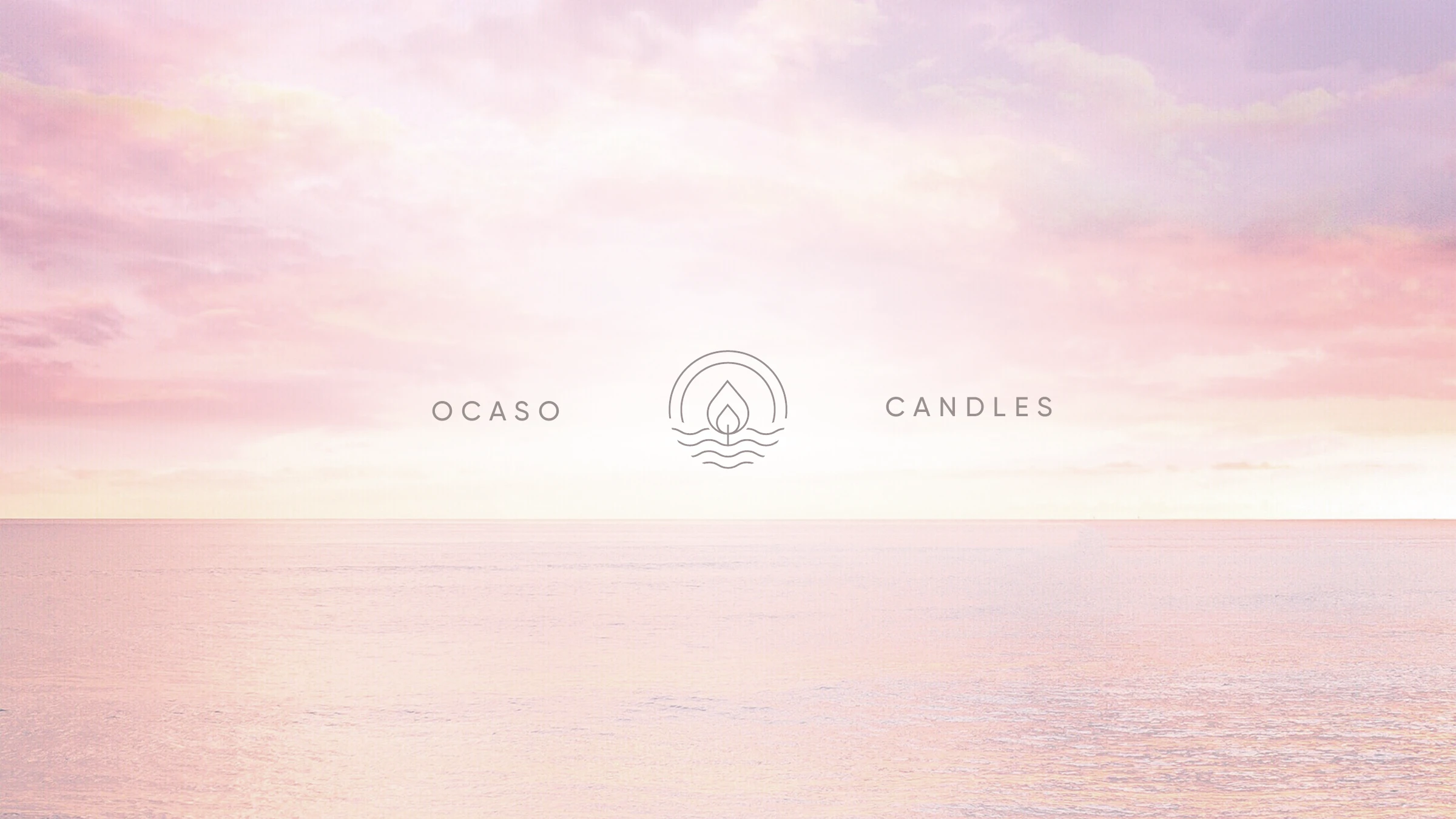 OCASO Candles — the wordmark and flame-on-horizon isotype over a soft sunset sea