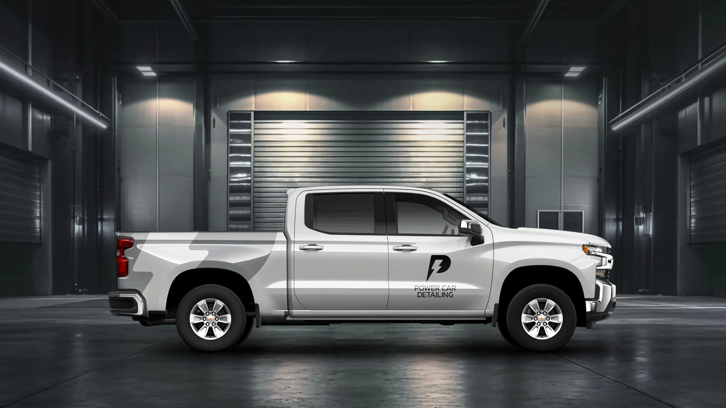 White Chevrolet Silverado wrap with the black-and-grey lightning Power Car Detailing graphic