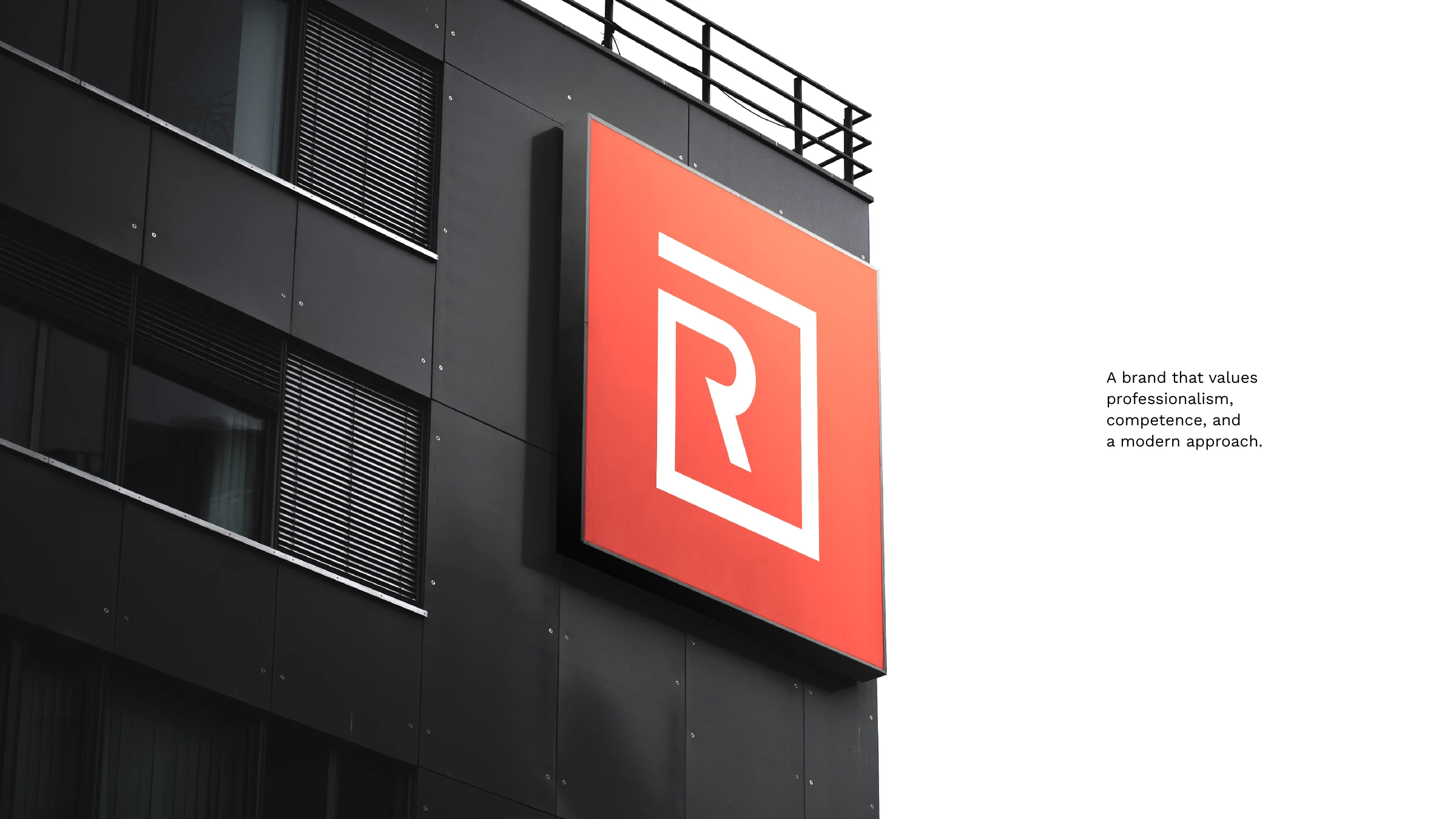 An orange Renovation Office R sign mounted on a dark building facade