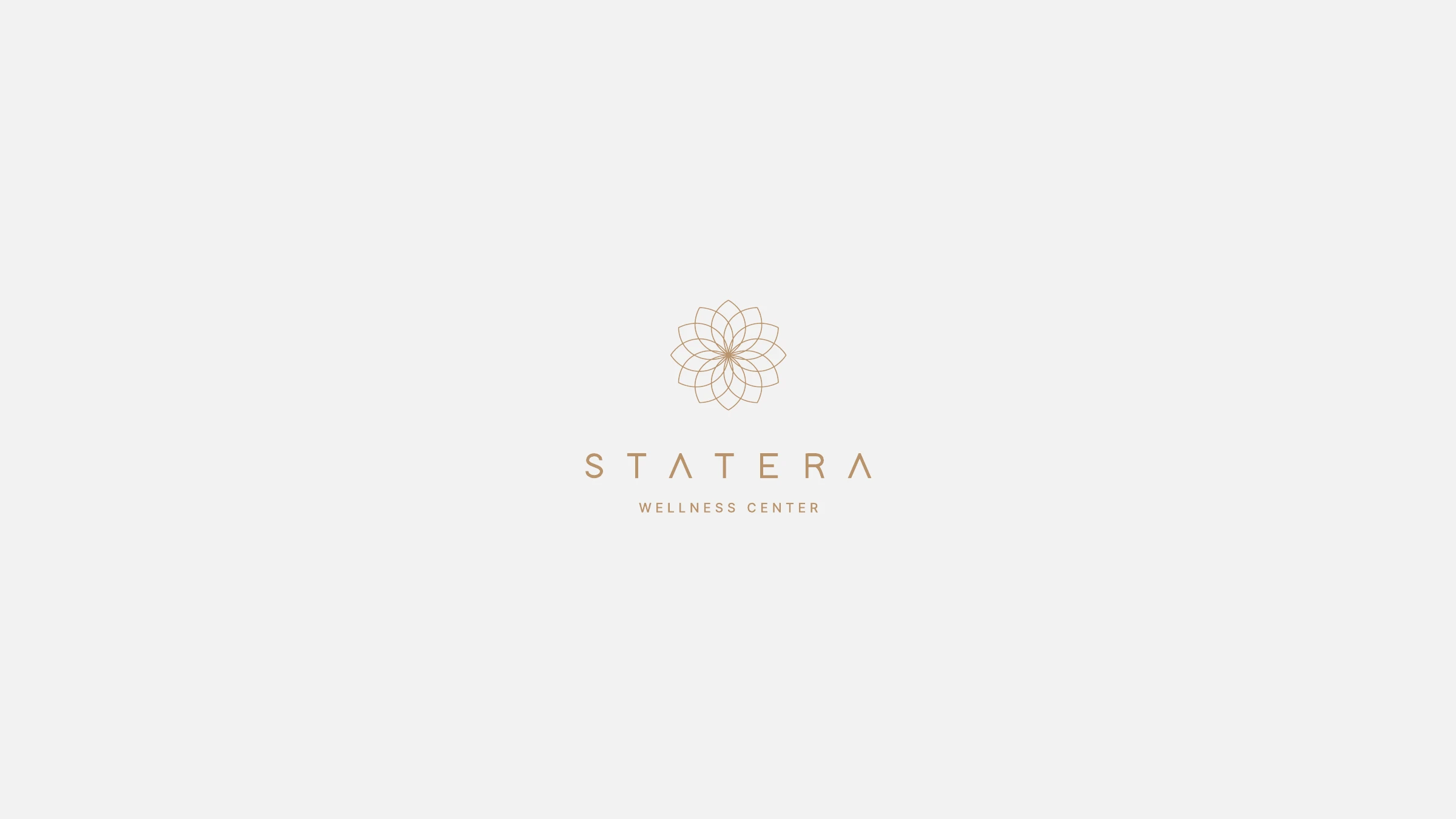 The STATERA Wellness Center lockup in gold on light grey