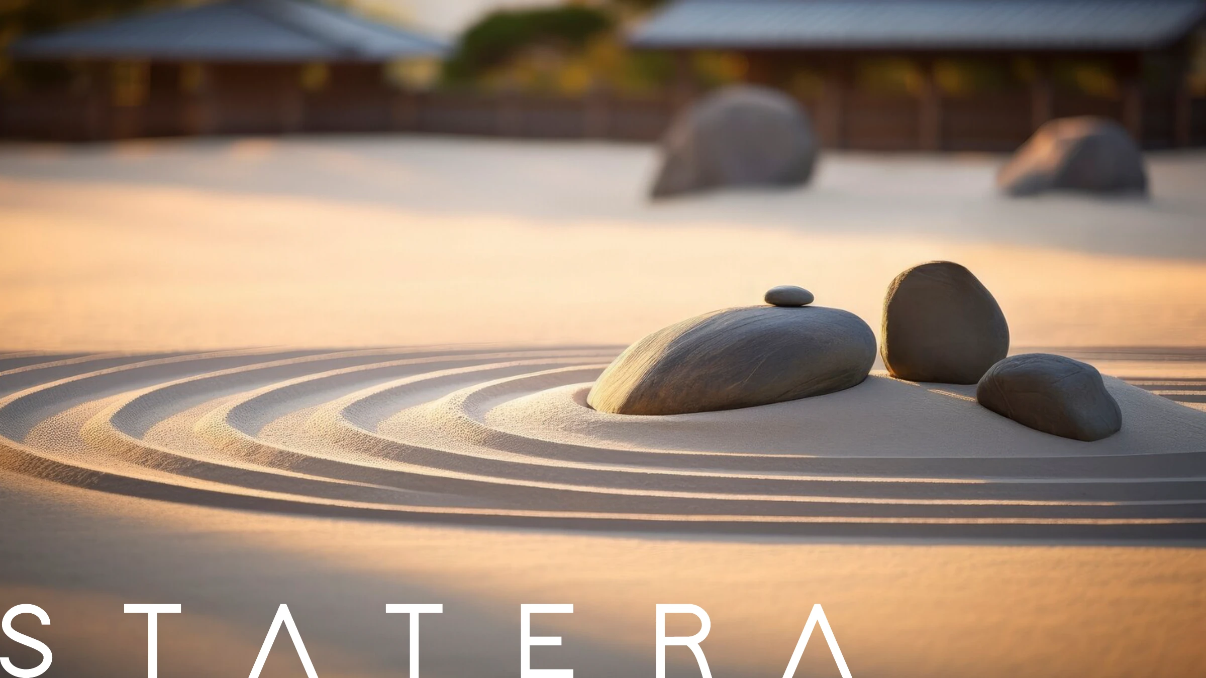 STATERA set over a raked zen sand garden with balanced stones at sunset