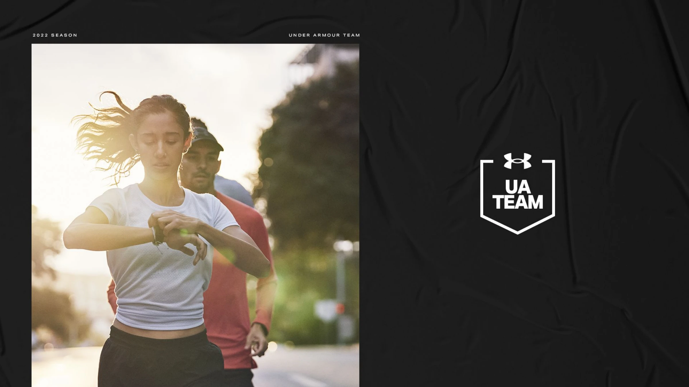 Direction 02 — the UA Team shield/pennant crest in white on black beside a woman runner checking her watch