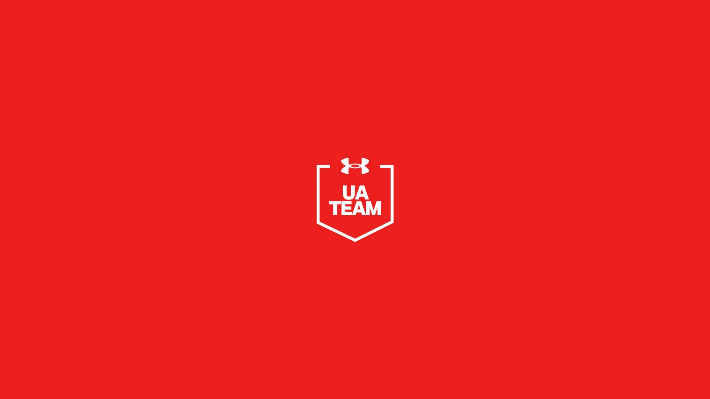Direction 02 — the UA Team shield crest centered, clean, in white on red